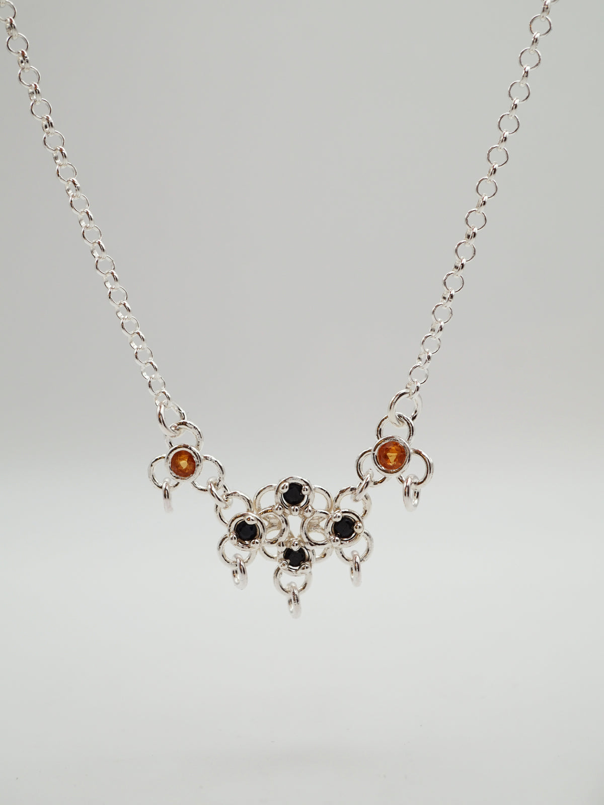 sterling silver TRAME necklace with blue and orange sapphires